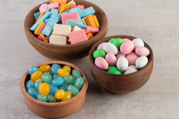 close-up-photo-various-kinds-gums-inside-bowls-grey-background