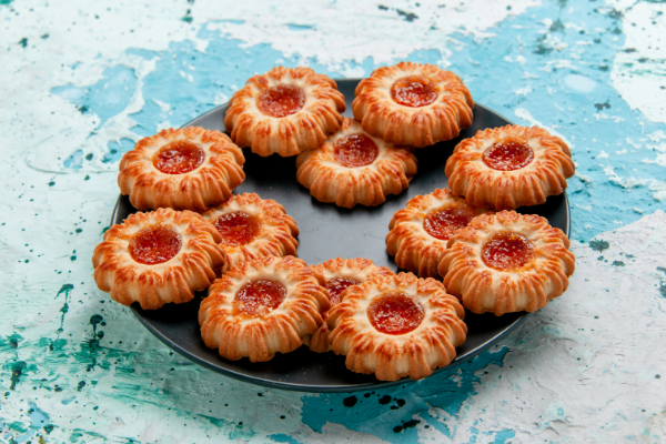 front-view-delicious-cookies-with-jam-inside-black-plate-blue-desk-cookie-biscuit-sweet-sugar-color-tea