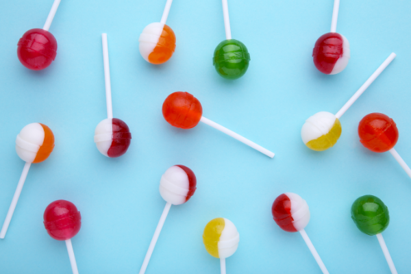 many-colorful-lollipops-blue-table-sweet-candy-concept