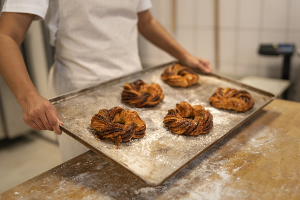 side-view-hands-holding-pastry-tray