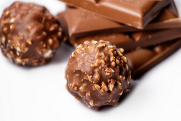 top-view-chocolate-candy-balls-with-chocolate-bars-white-surface