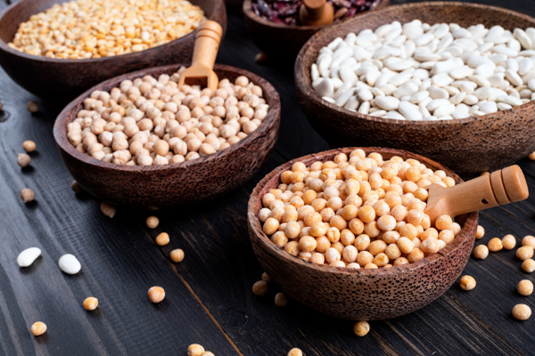 various-dried-legumes-wooden-bowls-wooden-rustic-background