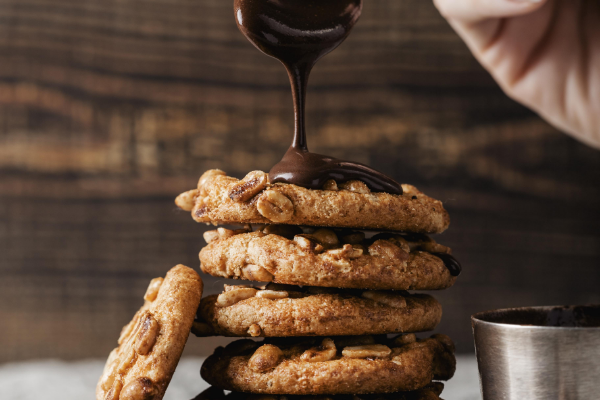 woman-pouring-chocolate-delicious-cookies